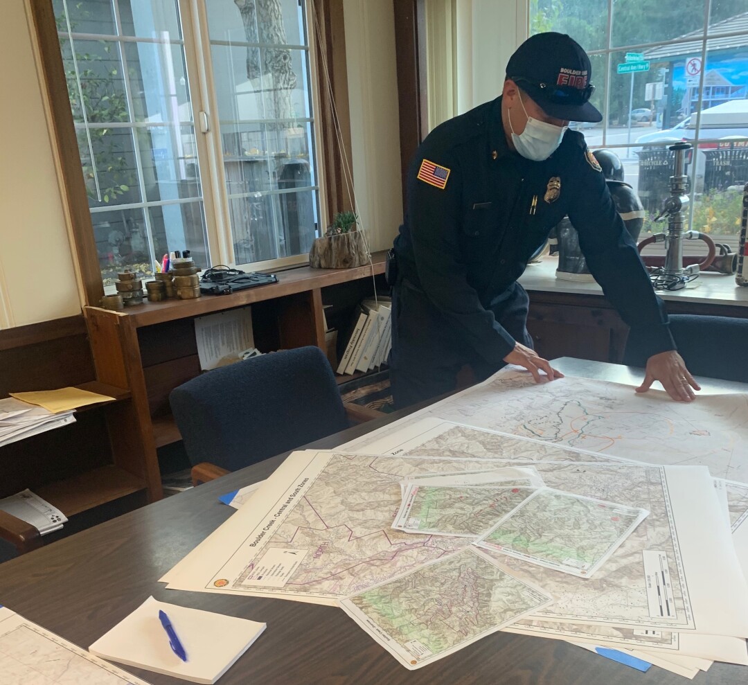 Mark Bingham, fire chief of the Boulder Creek Fire Protection District, surveys maps he's prepared.